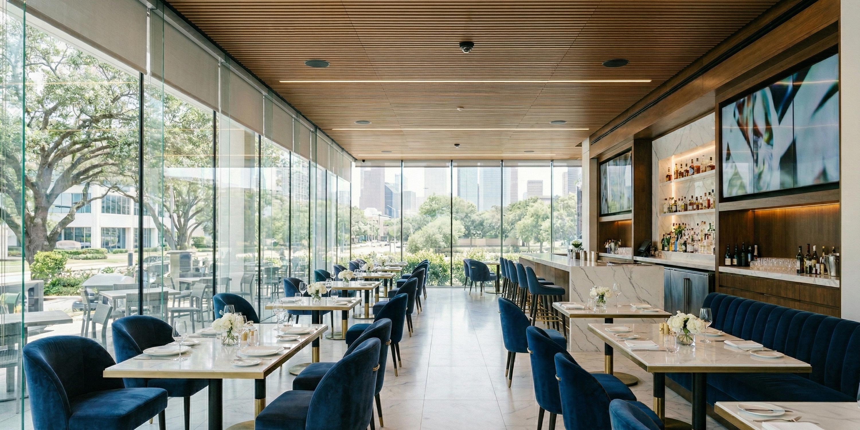 Elegant restaurant dining room with marble tables and velvet blue chairs