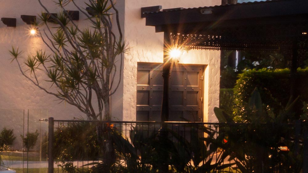Bright motion-sensor security floodlight for property perimeter