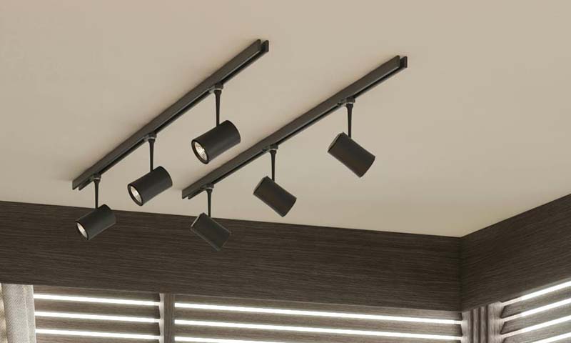 Adjustable track lighting heads on a ceiling rail