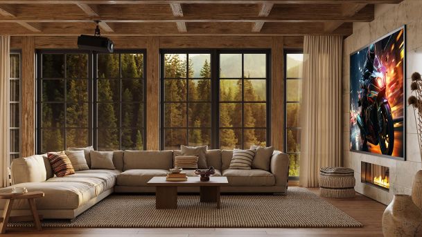 Rustic living room with a large screen showing a motorcycle and a view of pine trees