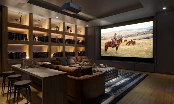 Cozy media room with leather sofas and a screen showing a person on a horse