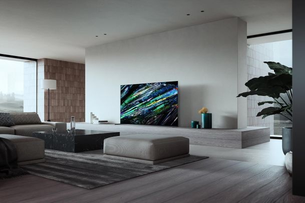 Minimalist living room with a thin television displaying colorful abstract art
