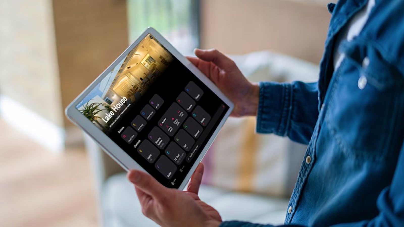 Tablet on a white counter displaying a smart home control interface for a living room