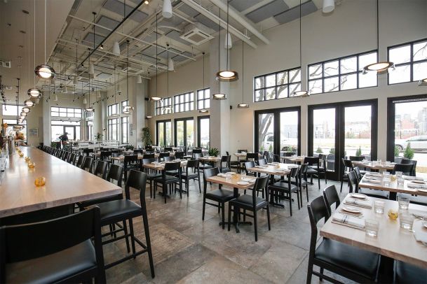 Spacious modern restaurant interior with many tables and large windows