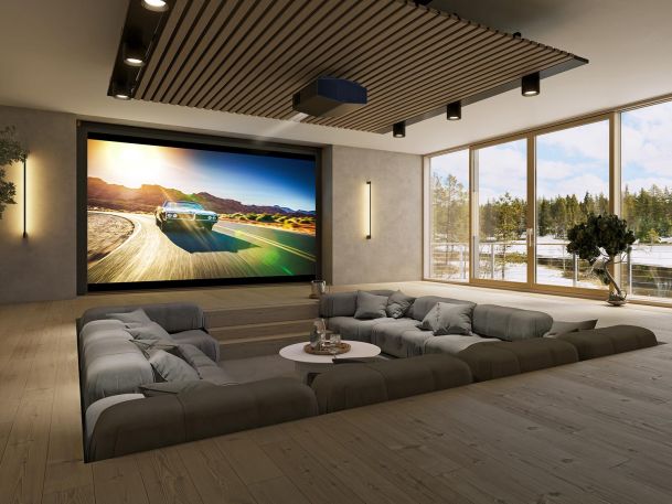 Modern home theater with a recessed seating area and a large screen showing a car